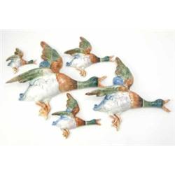 A set of five Royal Dux flying ducks, graduating in size from 17ins to 5.5ins, (some damage)...