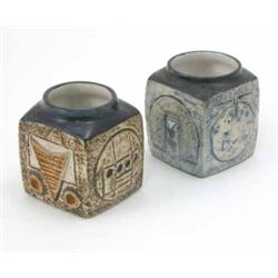 Two small Troika square shaped vases, one decorated with textured blue glazed sides, the other in...