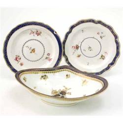 A group of five late 18th century Derby plates, decorated with a central blue and gilt scrolling...