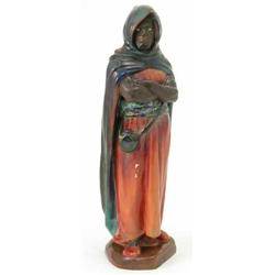 A Royal Doulton figure, The Moor, HN1308 or variant thereof, cloaked figure in red and mottled bl...