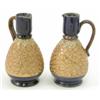 Image 1 : A pair of Royal Doulton glazed stoneware ewers, with ovoid bodies gilded and moulded with flowers...