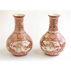 A pair of 19th century Kutani vases, of baluster form painted with dragon panels and chrysanthemu...