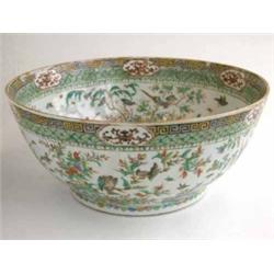 A 19th century Chinese porcelain punch bowl, painted with wild birds, flowers and foliage, 14.5in...