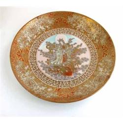A 19th century Kutani wall plate, painted with a mythological princess standing upon the back of...