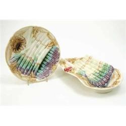 A French majolica style asparagus set, consisting of a dish and six plates moulded with forms of...