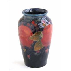A Moorcroft pomegranate pattern vase, on a dark blue ground, impressed M18, 5.5ins...