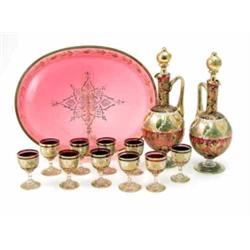A Continental gilded and enamelled ruby glass liqueur set, consisting of two globe and shaft deca...