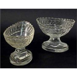 A pair of late George III cut glass boat-shaped salts, on pedestal stems and oval bases, 3ins hig...