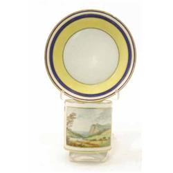 A rare late 18th century English porcelain cabinet cup and saucer, cylindrical cup painted with a...