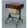 Image 1 : A Regency mahogany drop-flap work table, with ebony stringing, real and dummy drawers and pleated...