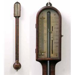 A George III mahogany stick barometer, with glazed arched door enclosing a silvered scale with th...