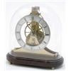 Image 1 : A modern skeleton timepiece by Dent, London, with silvered chapter ring, a three wheel train and...