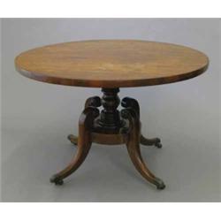 A Victorian mahogany breakfast table, circular top on turned pedestal, with platform base and fou...