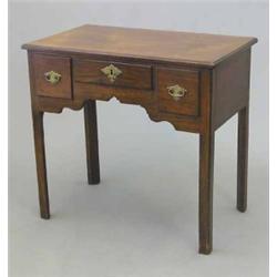 A George III mahogany lowboy, with three drawers on chamfered legs, 2ft 7ins...