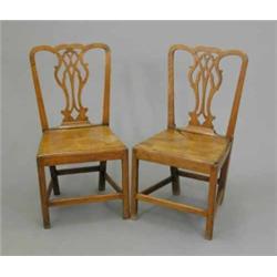 A pair of George III elm chairs, with pierced splat backs and solid seats, on chamfered legs...
