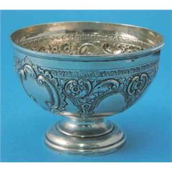 A Victorian silver rose bowl, decorated with an encircling band of 'C' scrolls and foliate swags...