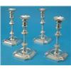 Image 1 : A set of four George V silver candlesticks, the double baluster faceted stems supported on shaped...