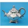 Image 1 : A Victorian silver teapot, of facetted form, decorated with engraved foliate motifs with scroll h...