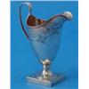 Image 1 : A George III helmet shaped silver cream jug, with fluted scroll handle and engraved with foliate...