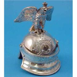 A late 19th century German 800 standard model helmet, with chin strap, mounted badge and surmount...
