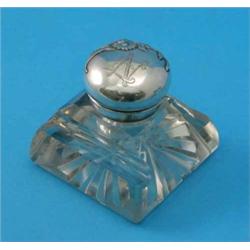 A Continental Art Nouveau white metal and glass inkwell, the hinged lid decorated with a floral s...