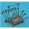 Image 1 : A Hukin & Heath silver plated toast rack, designed by Christopher Dresser, on ball toes, PODR 188...