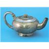 Image 1 : A silver teapot, of circular squat form with hammered finish and splayed base, maker APB London,...