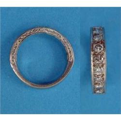 A diamond set white gold half eternity ring, size M...