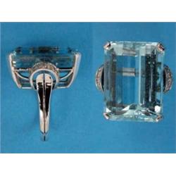 An aquamarine and diamond dress ring, the large rectangular-cut aquamarine flanked by diamond set...