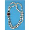 Image 1 : A 2-row pearl bracelet, the white gold clasp set with an oval ruby bordered by small diamonds sta...