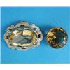 Image 1 : A single stone citrine brooch, in plain gold circular frame and an oval citrine brooch, in engrav...