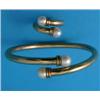 Image 1 : A yellow metal tubular stiff bangle, with cultured pearl terminals, and a matching ring...