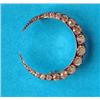Image 1 : A late Victorian gold and silver round crescent moon brooch, set with a graduated row of 21 diamo...