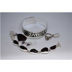 Selection of sterling silver jewellery including a native Hopi design cuff, a cats eye moonstone rin