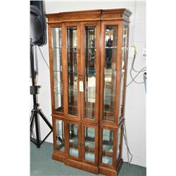 Semi contemporary illuminated four door display cabinet with multiple glass shelves and panels