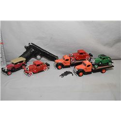 Six die cast toys including two flat deck trucks and four vintage style cars plus a cast metal repli