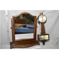 Gilbert reproduction banjo clock and a walnut tilting table top mirror