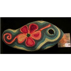 Scandinavian Stylized Fish with floral design made from woven wool.with what appears to be a wooden 