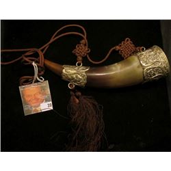 Bull Horn hangar with woven cord, pewter caps inlaid with turquoise inset.