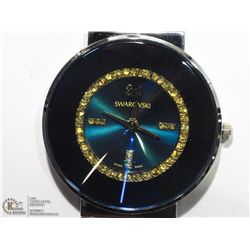 11) BLUE FACE SWAROVSKI WATER RESISTANT WATCH.
