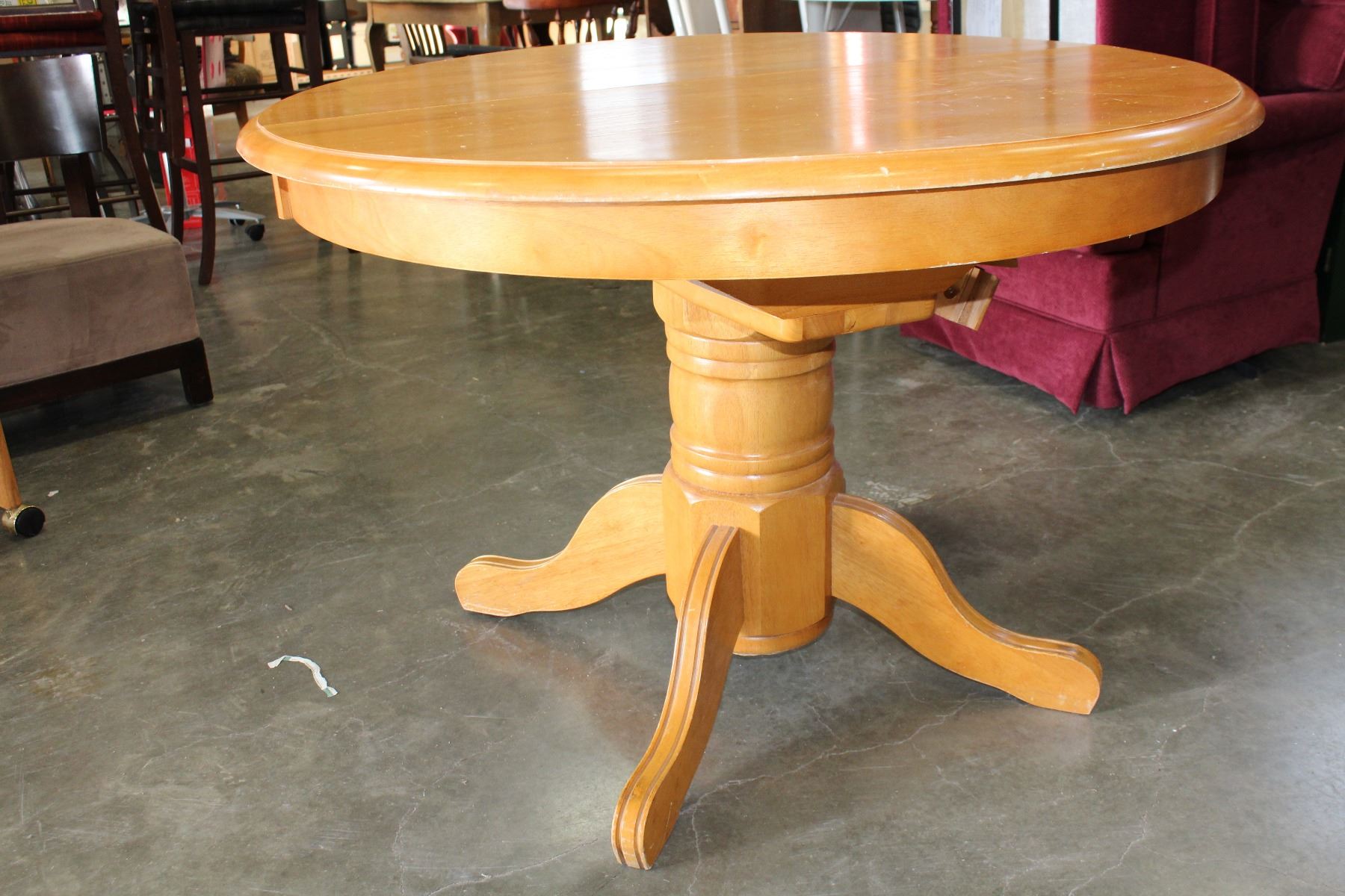 ROUND MAPLE DINING TABLE WITH JACK KNIFE LEAF AND FOUR OAK ROLLING