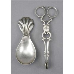 A pair of George II silver sugar tongs, of typical scissors form, with ring handles and shell nip...