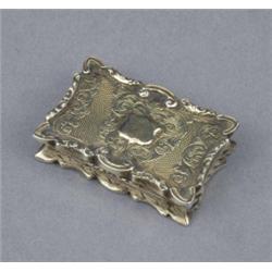 A Victorian silver vinaigrette, of shaped rectangular outline, the engine turned cover engraved w...