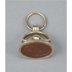 A George III gold oval fob seal, with beaded openwork kidney shaped mount, the carnelian matrix e...