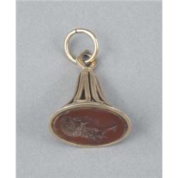 A George III gold oval fob seal, with reeded openwork loop mount, the carnelian matrix engraved w...