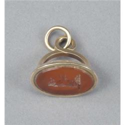 A George III gold fob seal, with divided loop mount, the oval carnelian matrix engraved with cres...