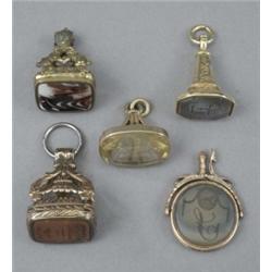 Four George III gilt-metal fob seals and a George III gold mounted circular agate swivel seal (fa...