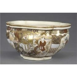 A Satsuma quatrefoil bowl, painted and gilt with figures and flowers in panels on a trellis and c...