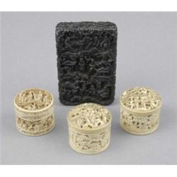 A Chinese ebony rectangular card case, deeply carved with figures in gardens with palms and flowe...
