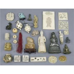 A quantity of Chinese, Japanese and other Eastern ivory carvings, including two small Chinese ova...